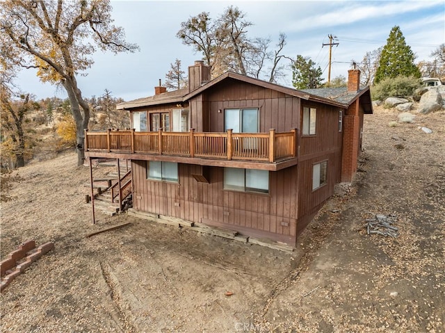 rear view of house with a wooden deck