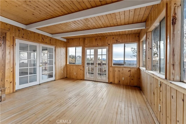 unfurnished sunroom with beamed ceiling, french doors, plenty of natural light, and wooden ceiling