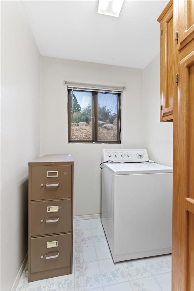 washroom with washer and dryer and cabinets