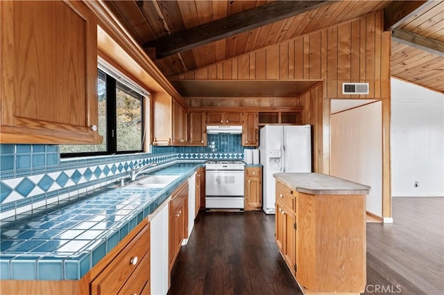 kitchen with decorative backsplash, white appliances, sink, wooden ceiling, and a kitchen island