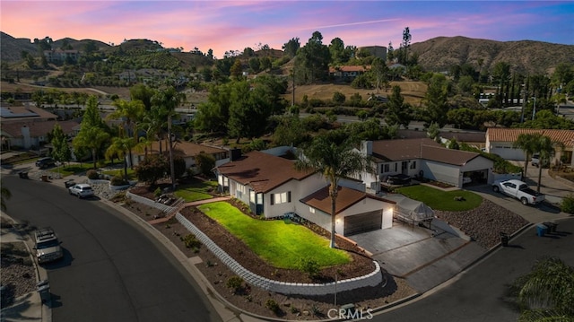 aerial view at dusk featuring a mountain view