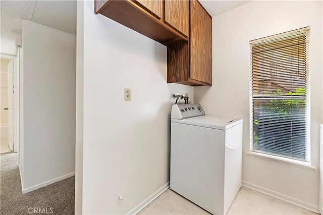 laundry area featuring cabinets and washer / dryer