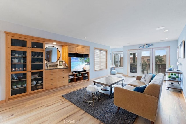 living room with light wood-type flooring and french doors