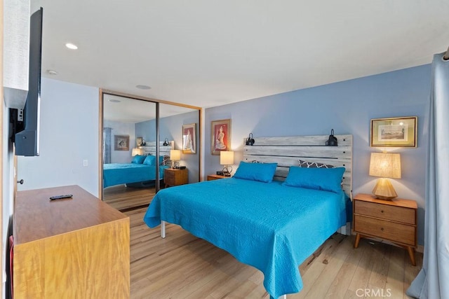 bedroom featuring light wood-type flooring and a closet