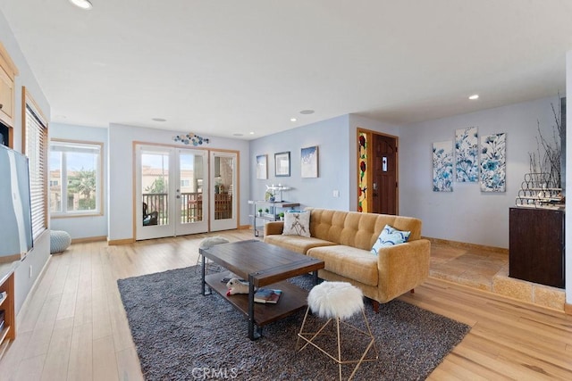 living room featuring french doors and light hardwood / wood-style flooring