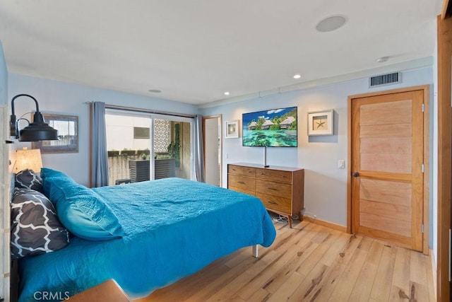 bedroom with access to outside and light wood-type flooring