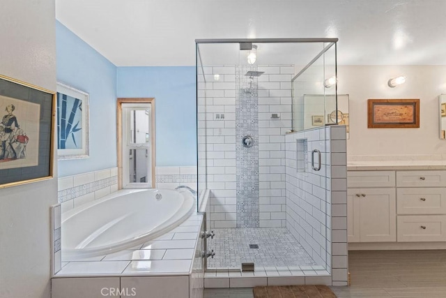 bathroom featuring separate shower and tub and vanity