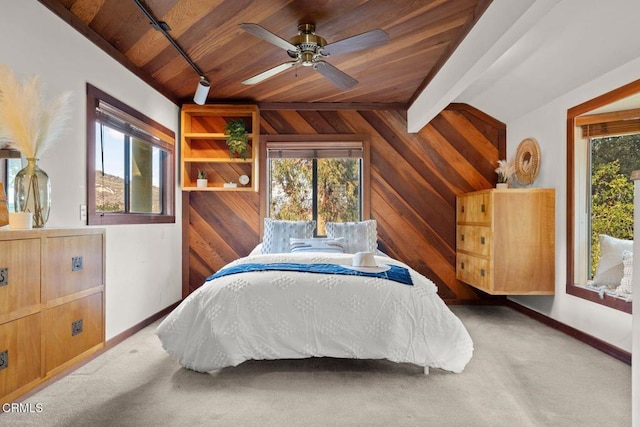 bedroom with carpet floors, wood ceiling, multiple windows, and wood walls