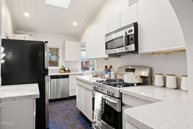 kitchen featuring stainless steel appliances, ornamental molding, and white cabinetry