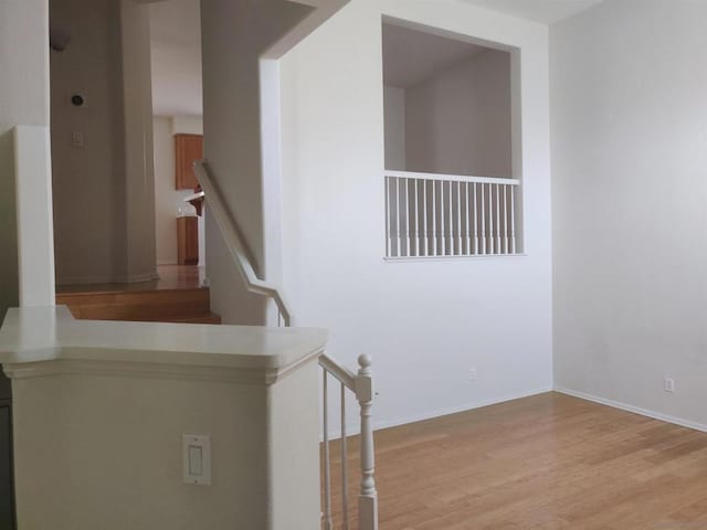 stairway featuring wood-type flooring