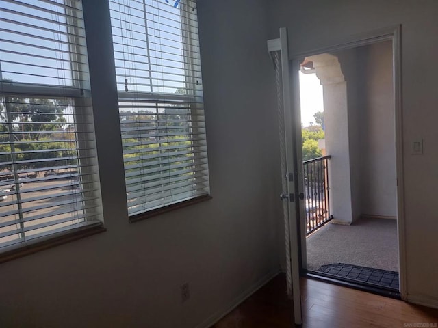 doorway to outside featuring dark wood-type flooring