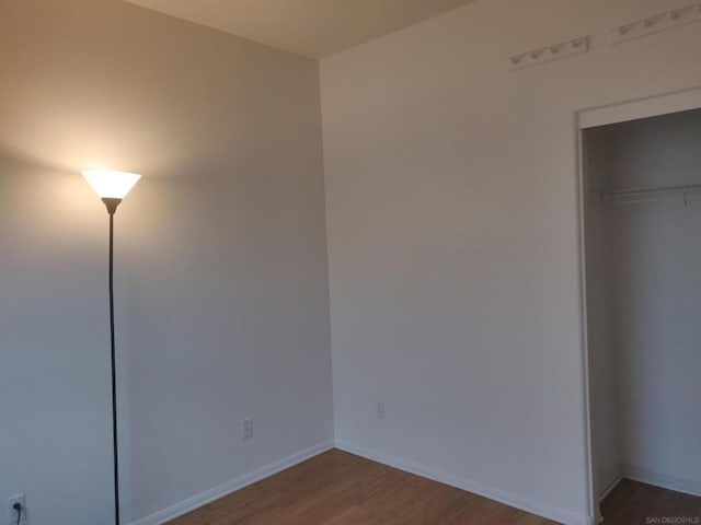 unfurnished bedroom with a closet and wood-type flooring