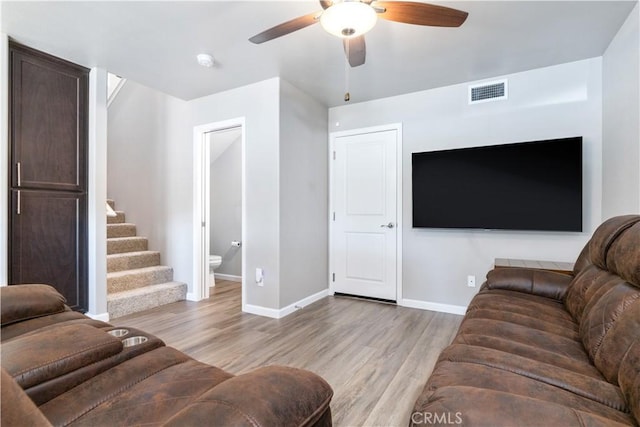 living room featuring ceiling fan and light wood-type flooring