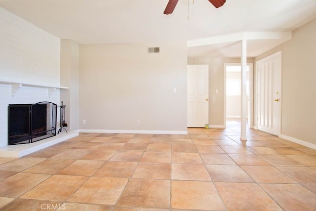 unfurnished living room with a fireplace, ceiling fan, and light tile patterned flooring