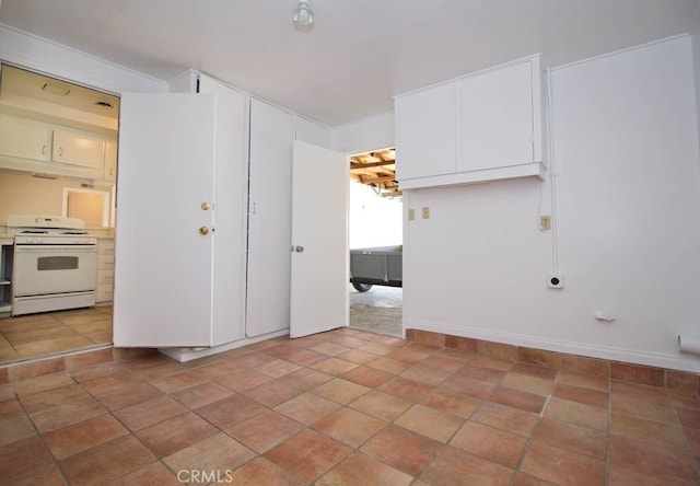 interior space with tile patterned floors and white gas range