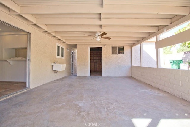 view of patio / terrace with ceiling fan and sink