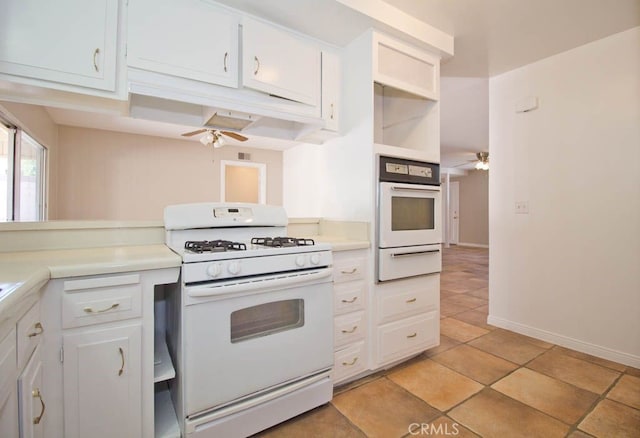 kitchen featuring white cabinets, light tile patterned floors, white appliances, and ceiling fan