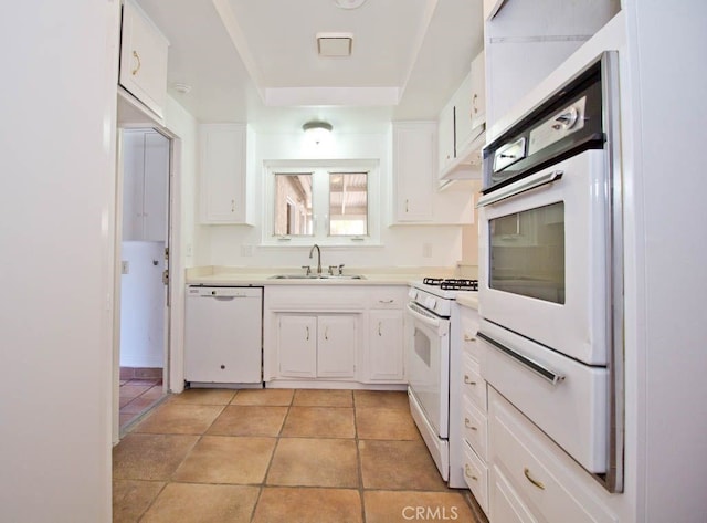 kitchen with white cabinets, white appliances, and sink