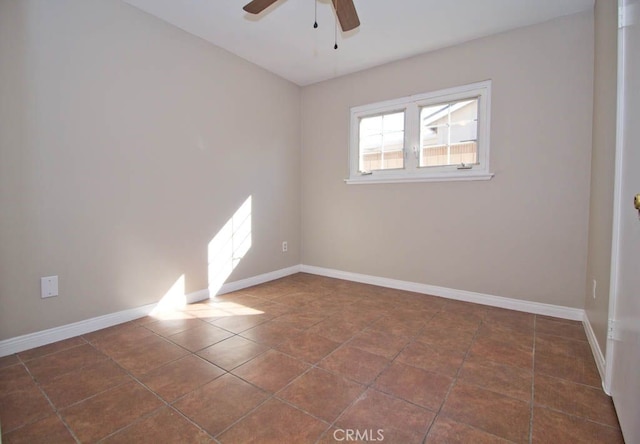 tiled spare room with ceiling fan