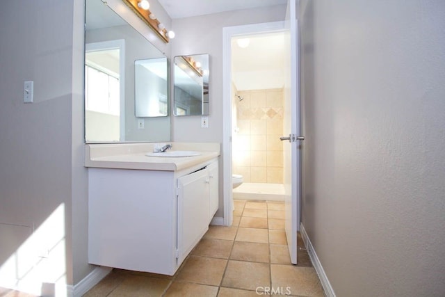 bathroom with a shower, vanity, tile patterned flooring, and toilet