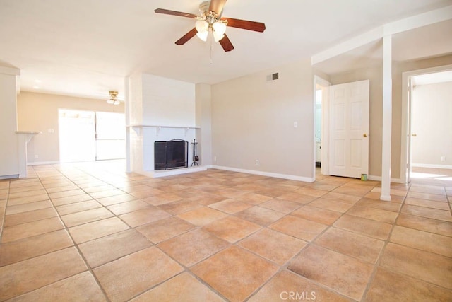 unfurnished living room featuring light tile patterned floors and ceiling fan