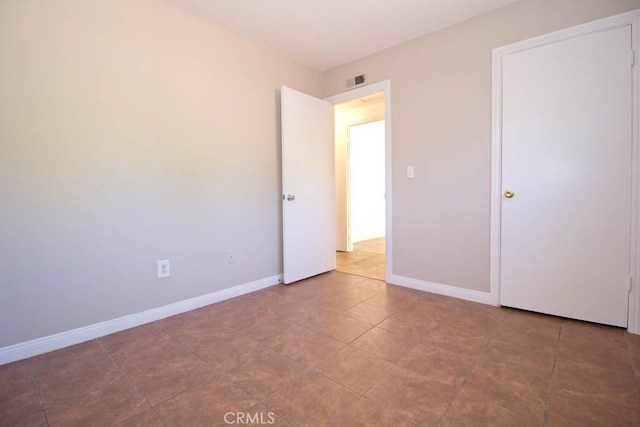 unfurnished bedroom with tile patterned floors