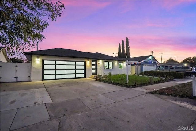 view of front of house with a garage and a yard