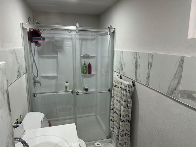 bathroom with toilet and walk in shower