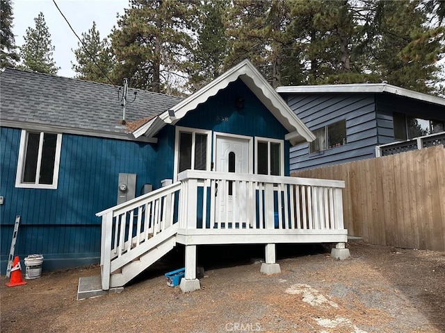 rear view of house with a wooden deck