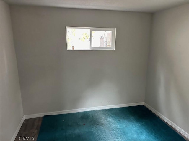 spare room featuring dark wood-type flooring