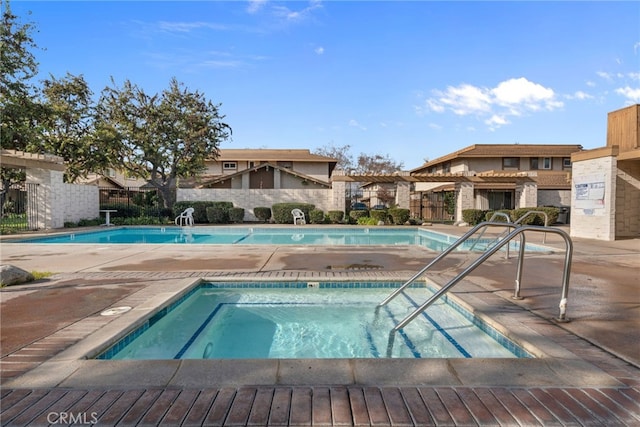 view of swimming pool featuring a community hot tub