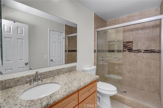 bathroom with toilet, walk in shower, and vanity