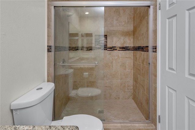 bathroom with toilet and an enclosed shower