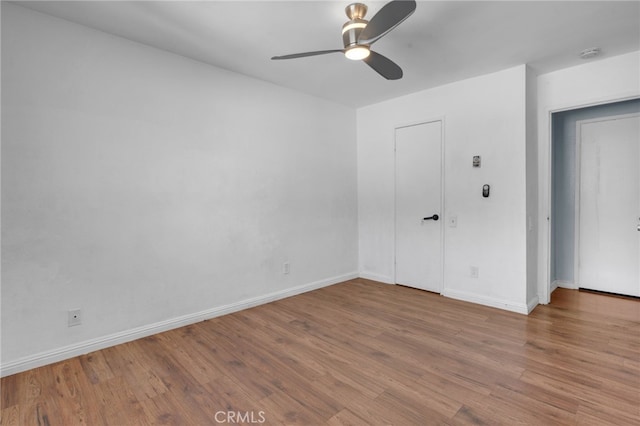 empty room with ceiling fan and wood-type flooring