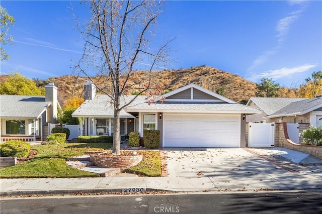 view of front of property with a mountain view and a garage