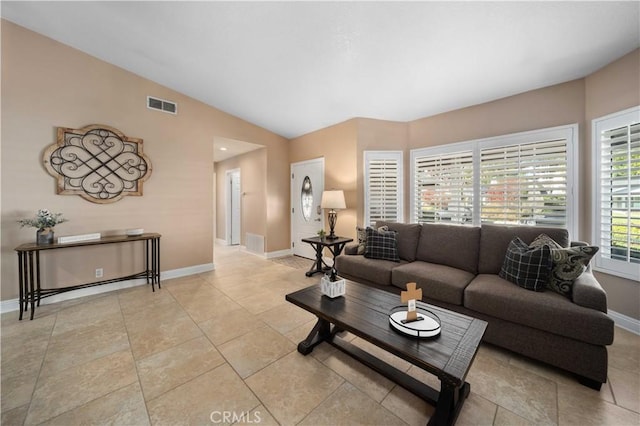 tiled living room featuring vaulted ceiling