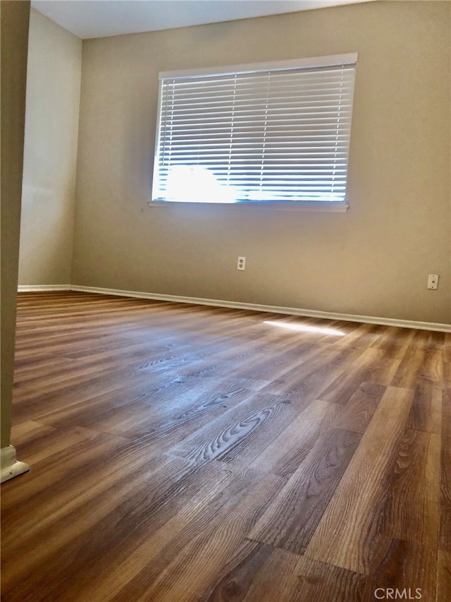 empty room with wood-type flooring