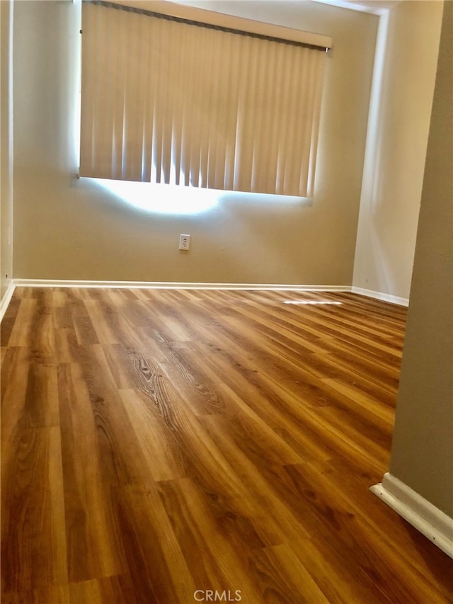 spare room with hardwood / wood-style flooring