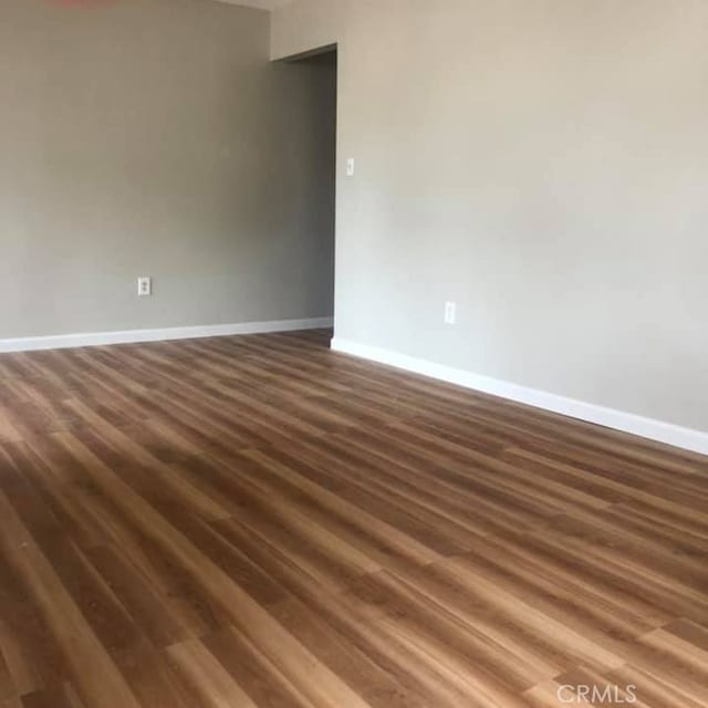 unfurnished room featuring dark hardwood / wood-style floors