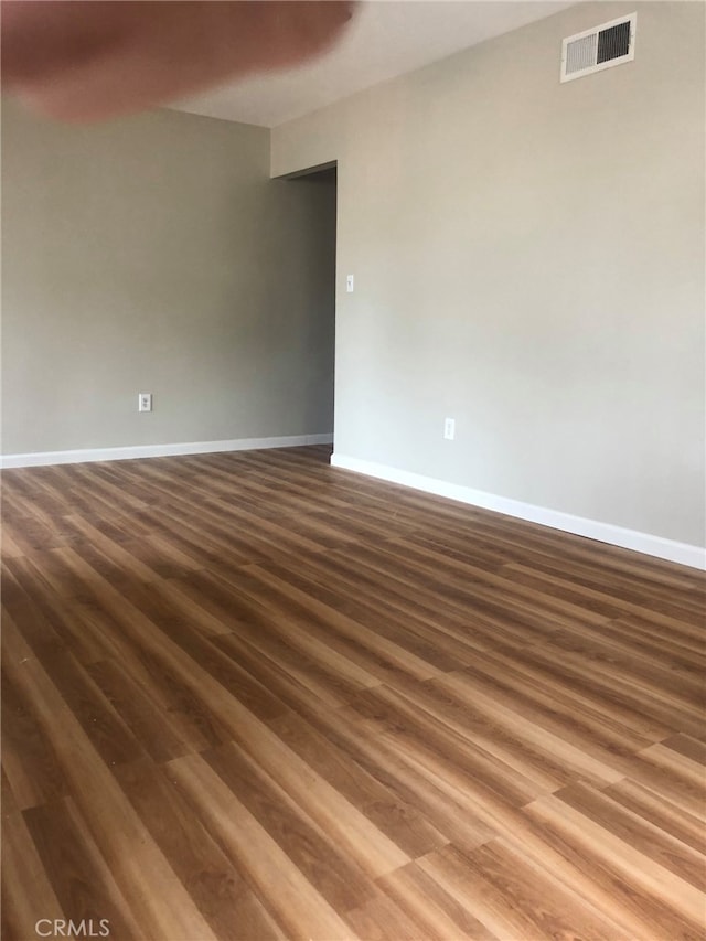 unfurnished room with dark hardwood / wood-style floors