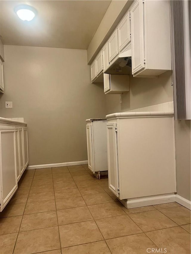 kitchen featuring white cabinetry and light tile patterned floors