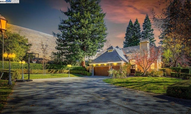 view of front of property featuring a yard and a garage