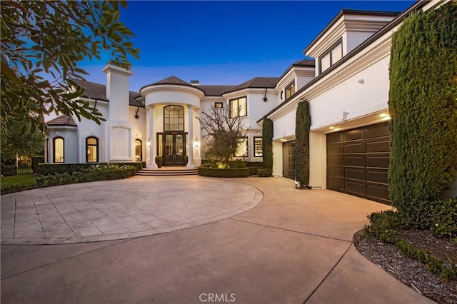 view of front of house with french doors and a garage