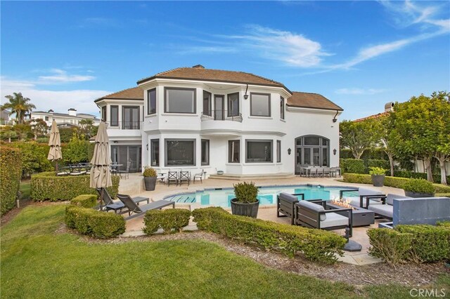 1 Moss Lndg, Laguna Niguel, CA 92677 - back of property with a balcony, an outdoor living space, a patio area, stucco siding, and an outdoor pool