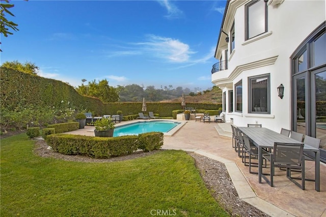 view of pool with a lawn and a patio area