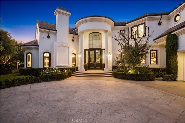 1 Moss Lndg, Laguna Niguel, CA 92677 - view of front facade with french doors, stucco siding, a tiled roof, and curved driveway