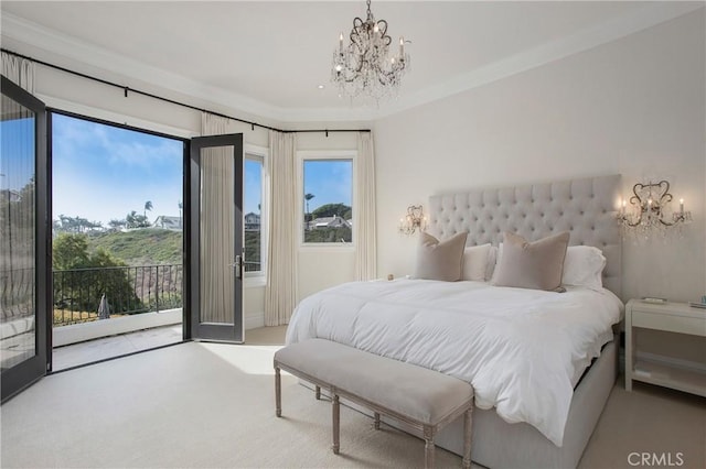 carpeted bedroom featuring access to outside and an inviting chandelier