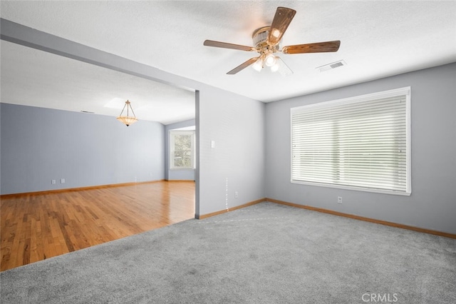 empty room featuring wood-type flooring and a textured ceiling