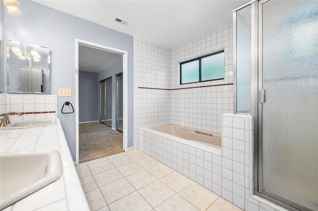 bathroom with tile patterned flooring, vanity, and separate shower and tub