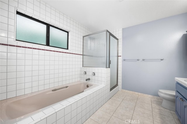 bathroom with tile patterned flooring, vanity, toilet, and walk in shower